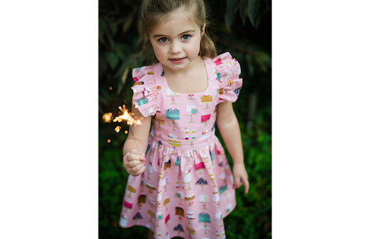 girl wearing cake dress with sparkler