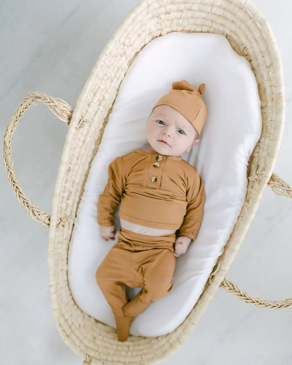 baby in camel colored outfit with hat