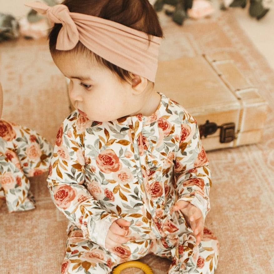 baby in floral zipper romper